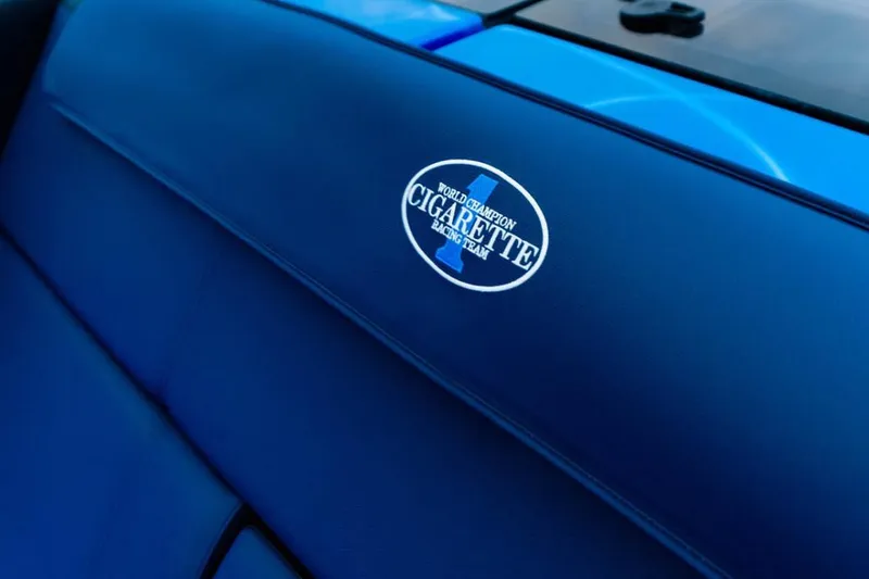 Slide: The Image of 2024 Cigarette 59 Tirranna interior with logo on blue upholstery. - 19