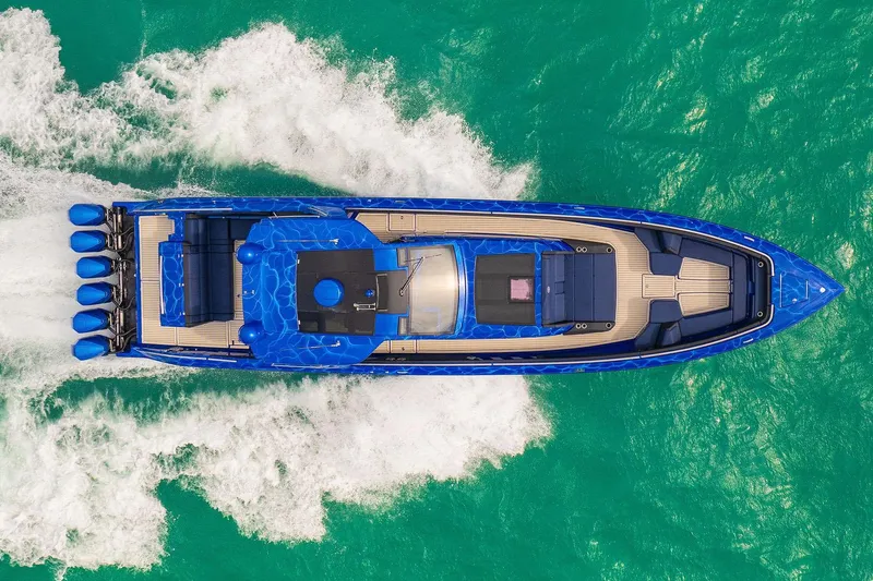 Slide: The Image of Manufacturer Provided Image: 2024 Cigarette 59 Tirranna luxury speedboat cruising on turquoise water. - 2