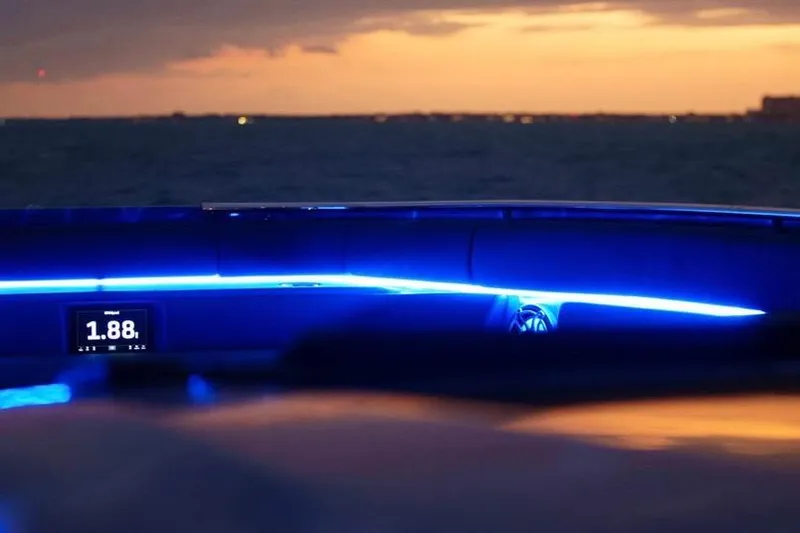 Slide: The Image of 2024 Cigarette 59 Tirranna boat interior with blue LED lighting at sunset. - 22