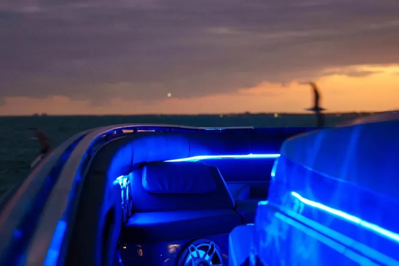 Slide: The Image of 2024 Cigarette 59 Tirranna boat interior with blue LED lighting at sunset. - 23