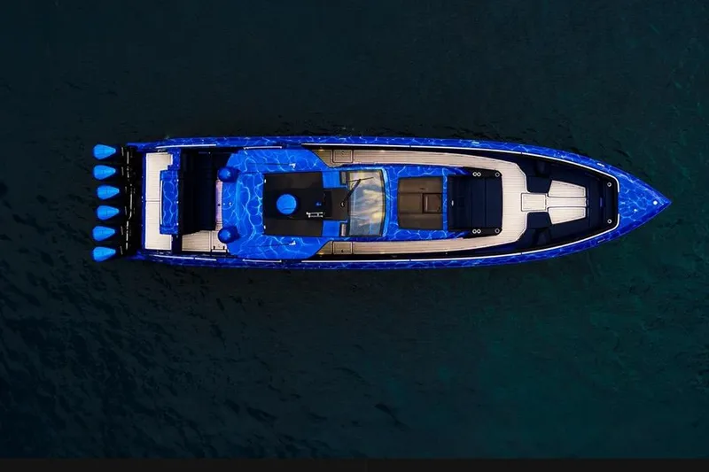 Slide: The Image of Aerial view of 2024 Cigarette 59 Tirranna boat with vibrant blue design on water. - 27
