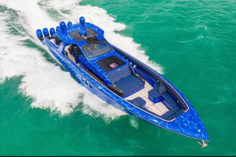 Slide: The Image of 2024 Cigarette 59 Tirranna speedboat cruising on turquoise water, showcasing sleek design. - 28