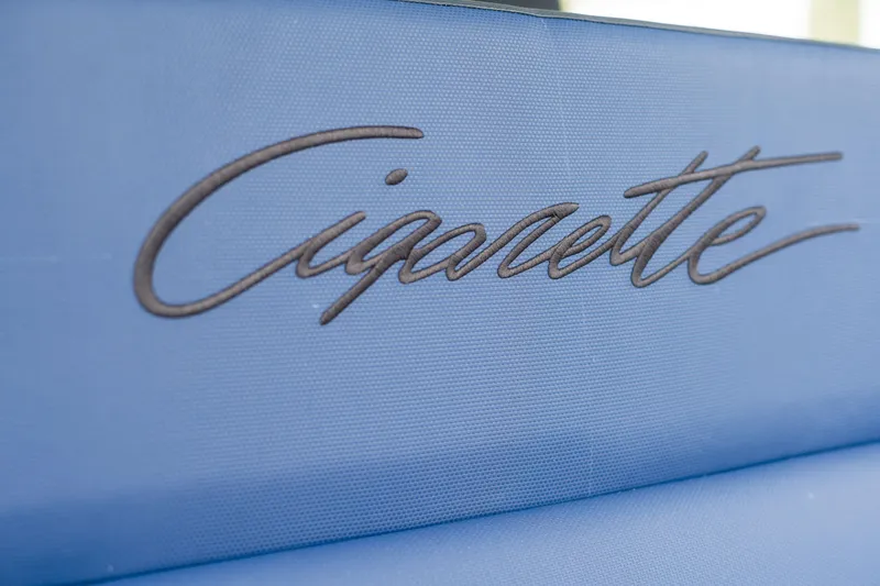 Slide: The Image of Manufacturer Provided Image: Cigarette 59 Tirranna 2024 logo on blue upholstery - 5