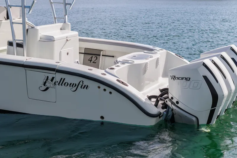 Slide: The Image of 2018 Yellowfin 42 Offshore boat with powerful outboard engines on calm water. - 11