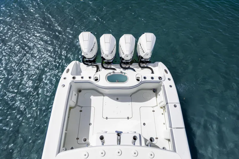 Slide: The Image of 2018 Yellowfin 42 Offshore boat with four outboard engines on blue water. - 12