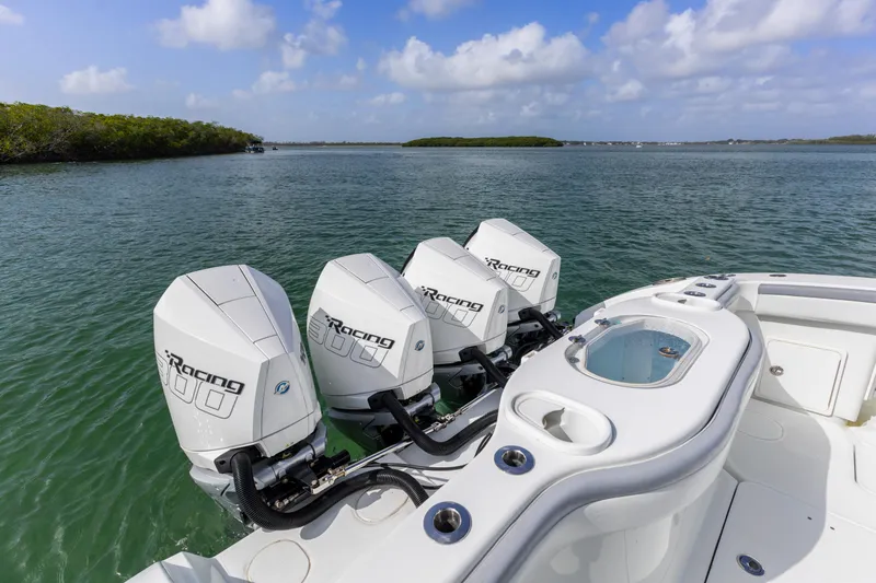 Slide: The Image of 2018 Yellowfin 42 Offshore boat with triple outboard engines on calm water. - 15