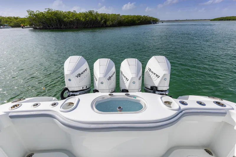 Slide: The Image of 2018 Yellowfin 42 Offshore boat with four powerful outboard engines on a serene waterway. - 16