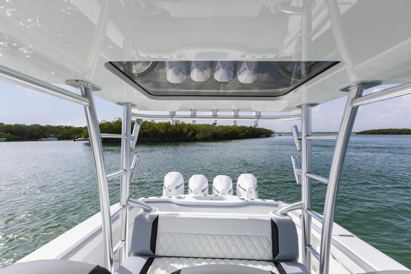 Slide: The Image of 2018 Yellowfin 42 Offshore boat with triple engines on a serene waterway. - 23