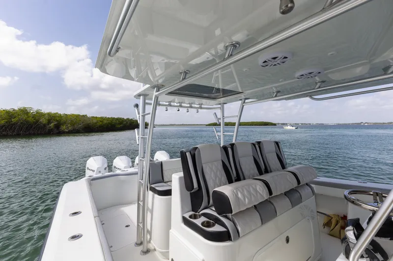 Slide: The Image of 2018 Yellowfin 42 Offshore boat interior with seating, on a calm waterway. - 24
