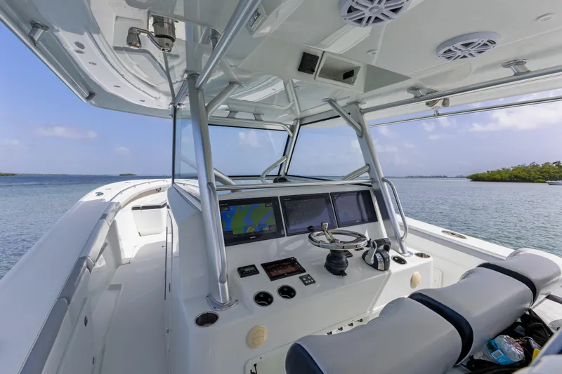 Slide: The Image of 2018 Yellowfin 42 Offshore boat cockpit with navigation screens and steering wheel. - 25