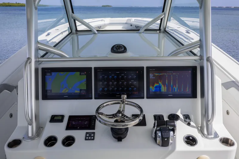 Slide: The Image of 2018 Yellowfin 42 Offshore boat dashboard with navigation screens and steering wheel. - 26