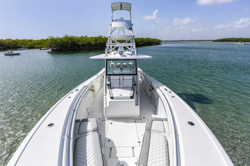 Slide: The Image of 2018 Yellowfin 42 Offshore boat on calm water, featuring spacious seating and sleek design. - 31