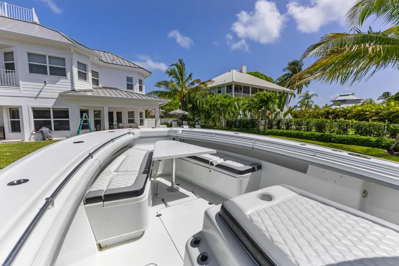 Slide: The Image of 2018 Yellowfin 42 Offshore boat docked near a luxurious waterfront home. - 32
