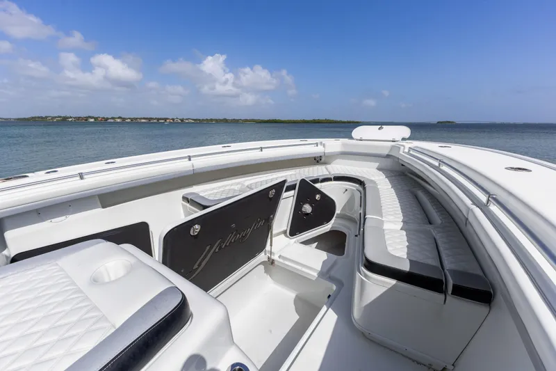 Slide: The Image of 2018 Yellowfin 42 Offshore boat interior with seating, ocean view, and clear sky. - 33