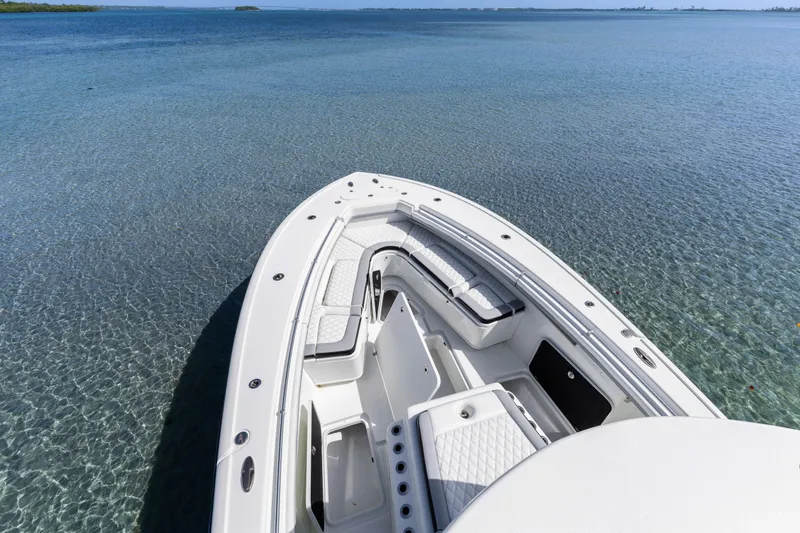 Slide: The Image of 2018 Yellowfin 42 Offshore boat on clear blue water, showcasing sleek design and spacious deck. - 35