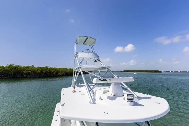 Slide: The Image of 2018 Yellowfin 42 Offshore boat on calm water under clear blue sky. - 36