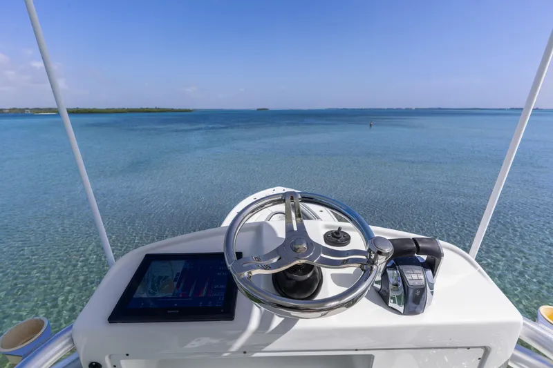 Slide: The Image of Helm view of 2018 Yellowfin 42 Offshore boat on clear blue water. - 38