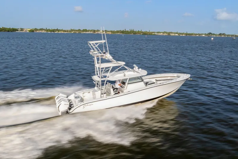 Slide: The Image of 2018 Yellowfin 42 Offshore boat speeding on open water under clear skies. - 4