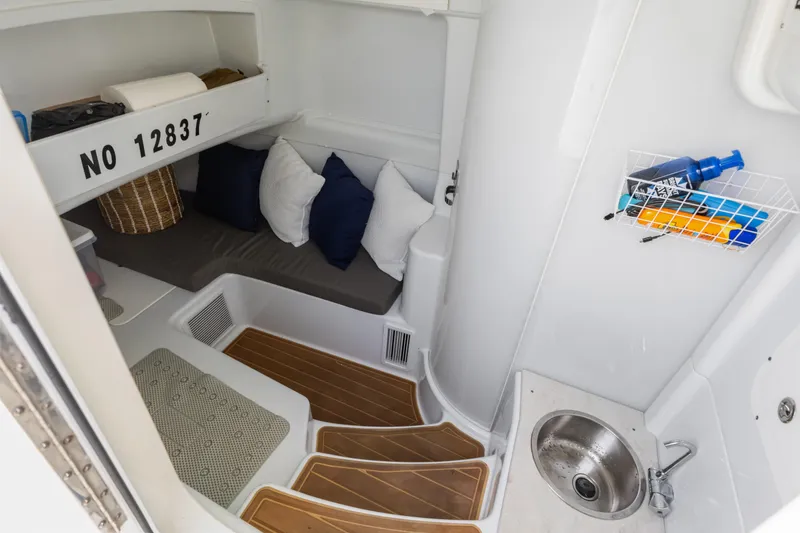Slide: The Image of 2018 Yellowfin 42 Offshore cabin interior with seating, sink, and storage. - 40