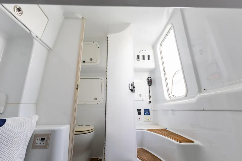 Slide: The Image of Interior of 2018 Yellowfin 42 Offshore boat, featuring a compact bathroom and seating area. - 41