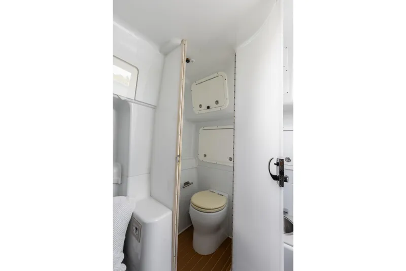 Slide: The Image of 2018 Yellowfin 42 Offshore boat bathroom interior with toilet and storage compartments. - 42