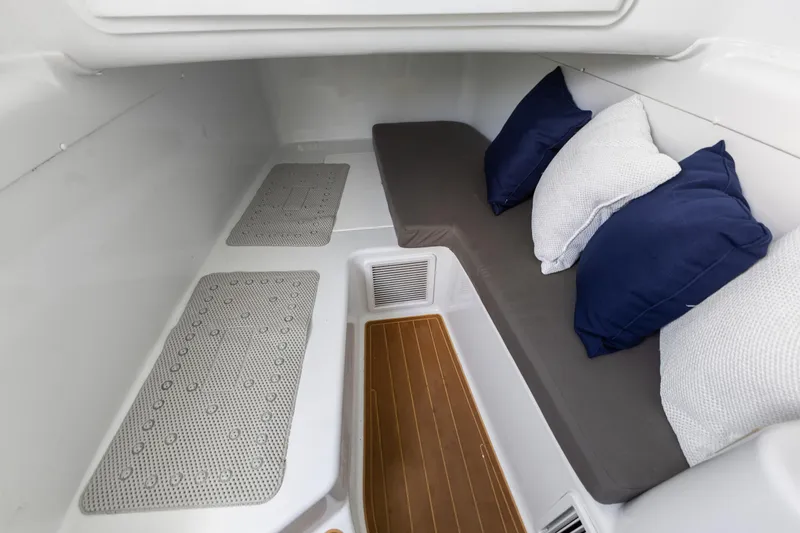 Slide: The Image of 2018 Yellowfin 42 Offshore cabin interior with cushions and wooden flooring. - 45