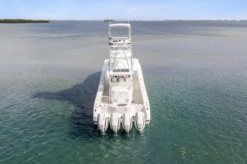 Slide: The Image of 2018 Yellowfin 42 Offshore boat with multiple engines on calm water. - 7