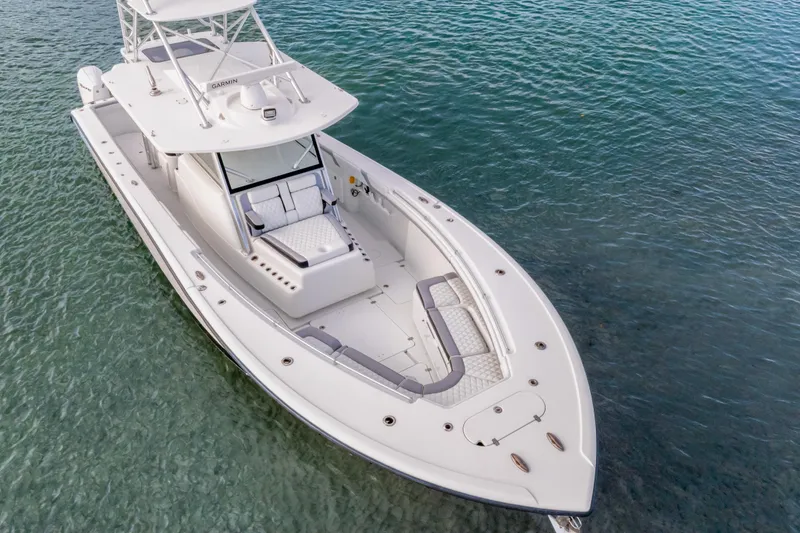 Slide: The Image of 2018 Yellowfin 42 Offshore boat on clear blue water, showcasing sleek design and spacious deck. - 8