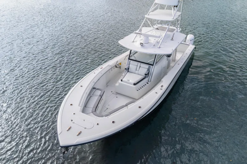 Slide: The Image of 2018 Yellowfin 42 Offshore boat on calm water, showcasing sleek design and spacious deck. - 9