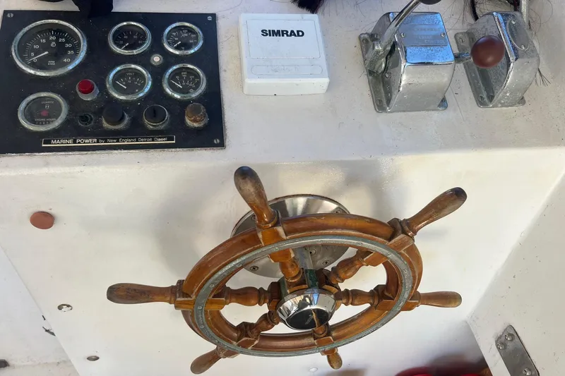 Slide: The Image of 1995 Young Brothers 38 fly bridge helm with wooden wheel and control panel. - 11