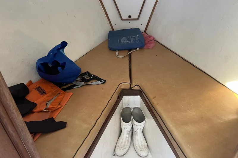 Slide: The Image of Interior of 1995 Young Brothers 38 Fly Bridge with boots and gear on cushions. - 14
