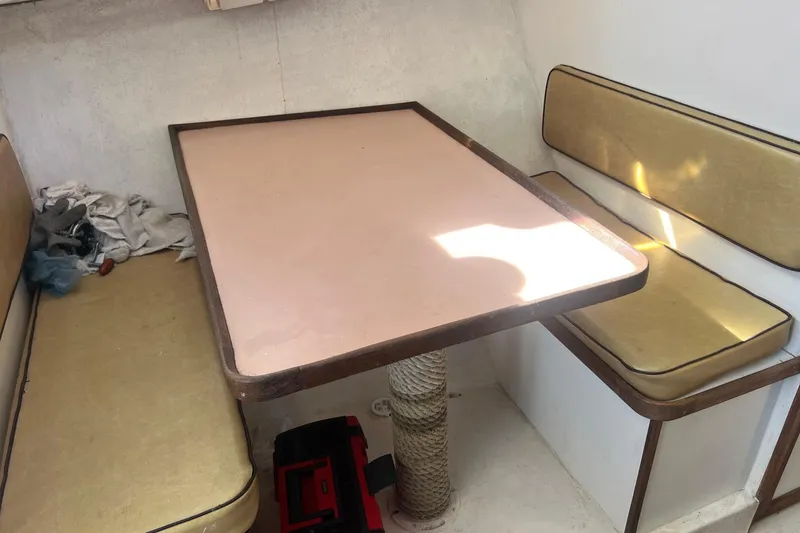 Slide: The Image of Interior of 1995 Young Brothers 38 Fly Bridge with table and cushioned seating. - 16