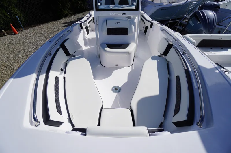 Slide: The Image of 2026 Tidewater 220 LXF boat interior with white seating and sleek design. - 10