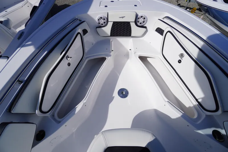 Slide: The Image of 2026 Tidewater 220 LXF boat interior with storage compartments and speakers. - 12