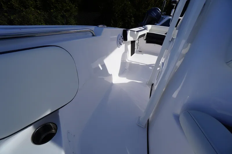 Slide: The Image of 2026 Tidewater 220 LXF boat interior with sleek white deck and modern design. - 16