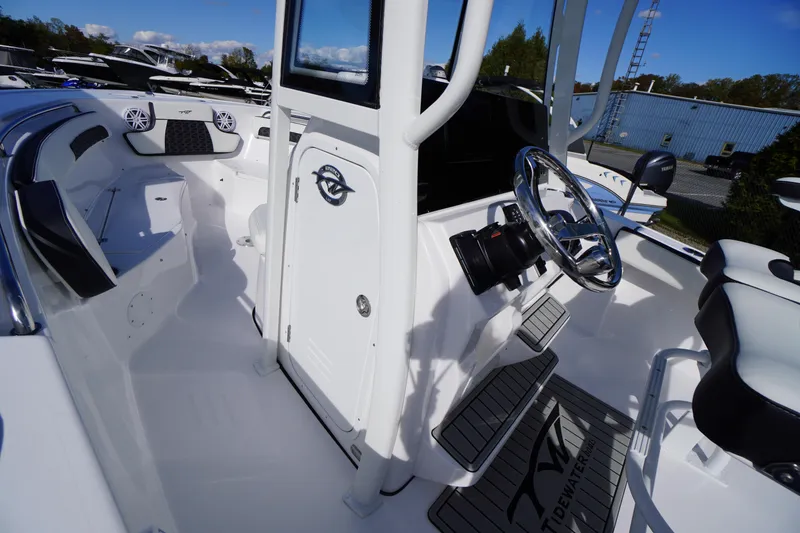 Slide: The Image of 2026 Tidewater 220 LXF boat interior with sleek design and modern steering console. - 19