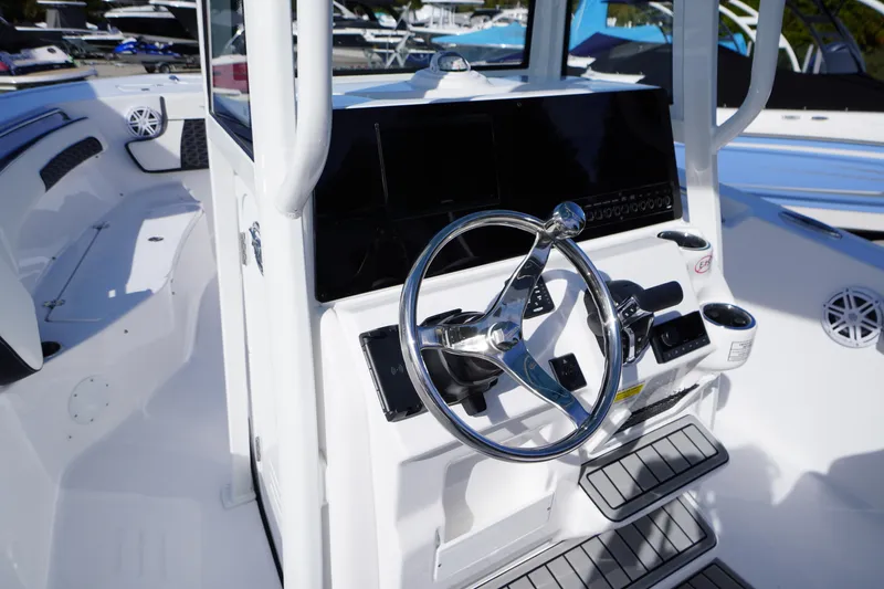 Slide: The Image of 2026 Tidewater 220 LXF boat cockpit with steering wheel and control panel. - 20