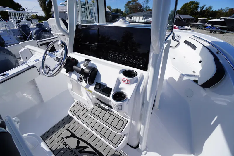 Slide: The Image of 2026 Tidewater 220 LXF boat cockpit with steering wheel and control panel. - 22