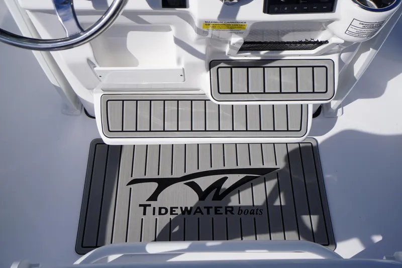 Slide: The Image of 2026 Tidewater 220 LXF boat interior with branded non-slip flooring. - 23