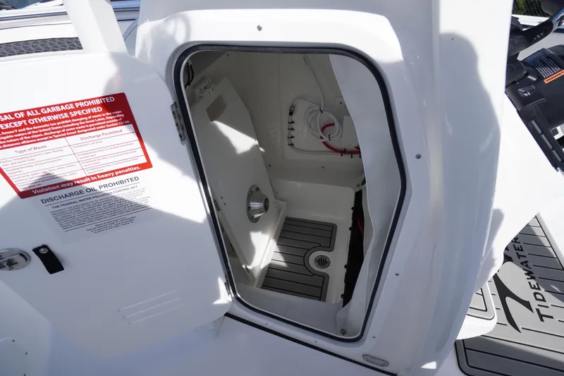 Slide: The Image of 2026 Tidewater 220 LXF boat interior storage compartment with safety instructions. - 26
