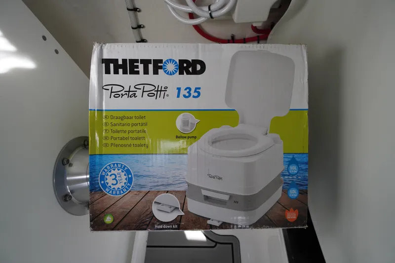 Slide: The Image of Box of Thetford Porta Potti 135 portable toilet inside 2026 Tidewater 220 LXF boat. - 28