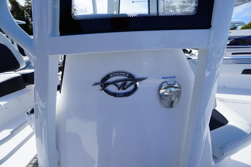Slide: The Image of 2026 Tidewater 220 LXF boat console with logo and fresh water access. - 31