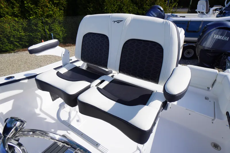 Slide: The Image of 2026 Tidewater 220 LXF boat seats with white and black upholstery, featuring armrests. - 32
