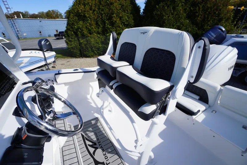 Slide: The Image of 2026 Tidewater 220 LXF boat interior with steering wheel and seating. - 34