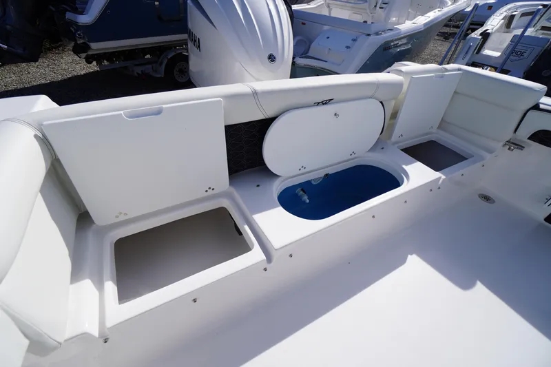 Slide: The Image of 2026 Tidewater 220 LXF boat interior with storage compartments and Yamaha engine. - 44