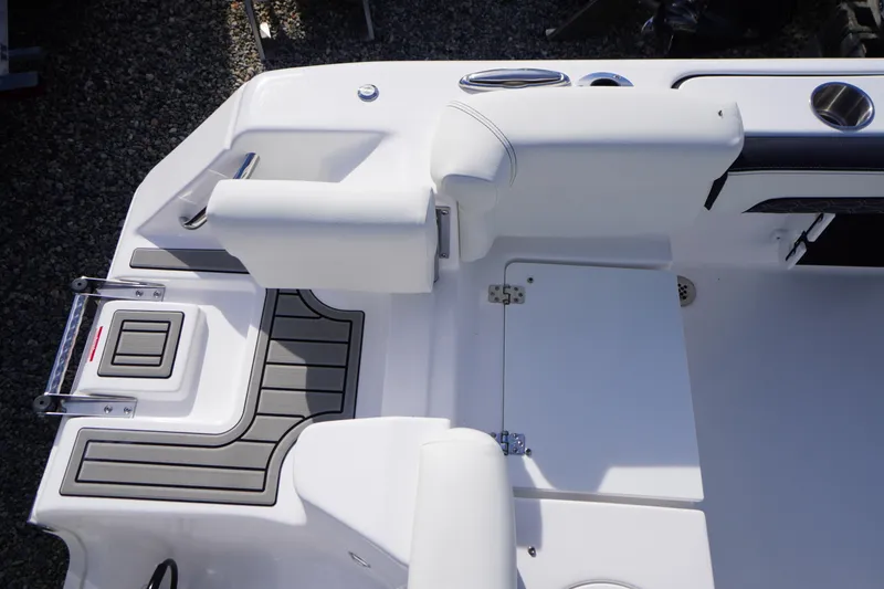 Slide: The Image of 2026 Tidewater 220 LXF boat interior with white seating and storage compartments. - 53