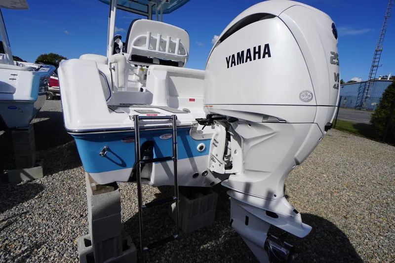 Slide: The Image of 2026 Tidewater 220 LXF boat with Yamaha engine, displayed on gravel lot. - 57