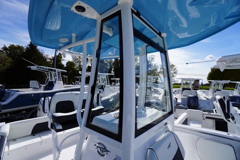 Slide: The Image of 2026 Tidewater 220 LXF boat with blue canopy, sleek design, and modern features. - 64