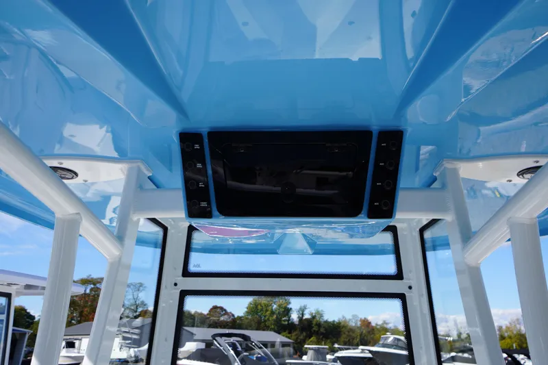 Slide: The Image of Interior view of 2026 Tidewater 220 LXF boat with blue ceiling and control panel. - 65