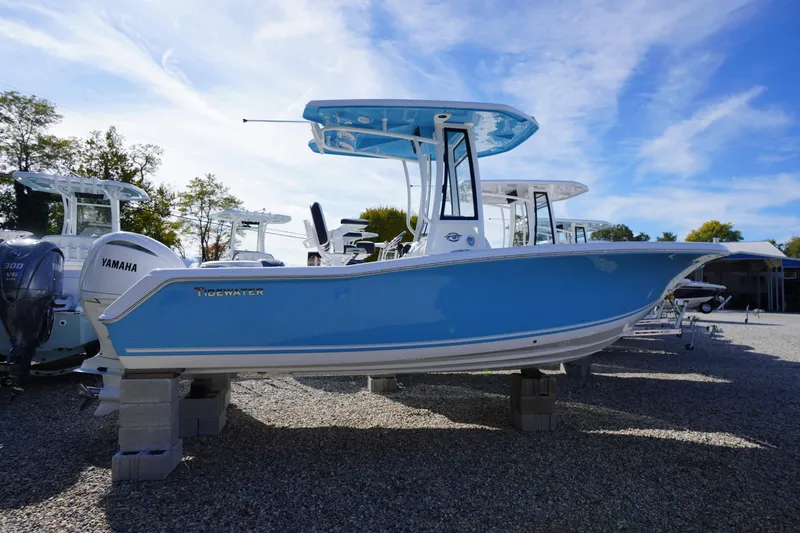 Slide: The Image of 2026 Tidewater 220 LXF boat with Yamaha engine, displayed outdoors on blocks. - 67